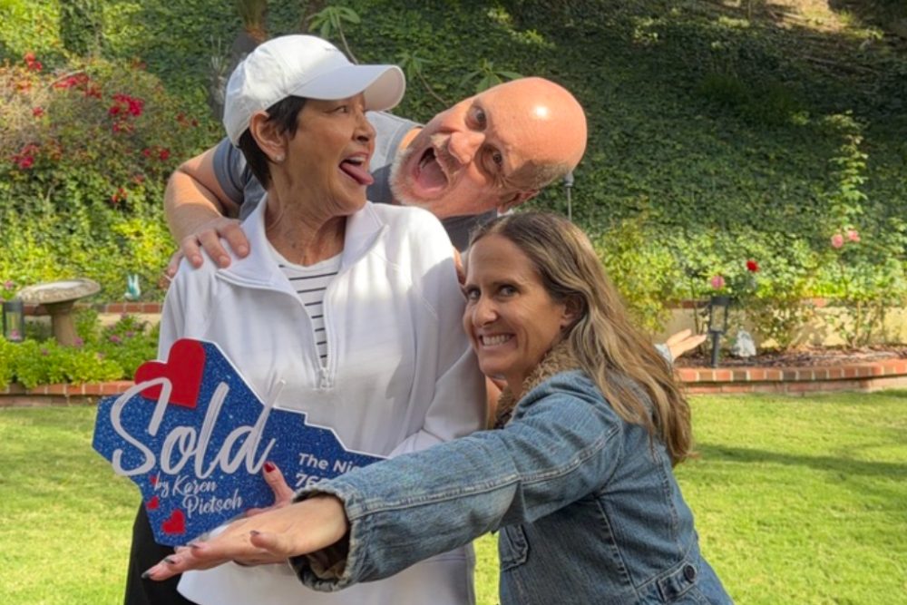 Smiling clients celebrating a successful home sale in North San Diego County