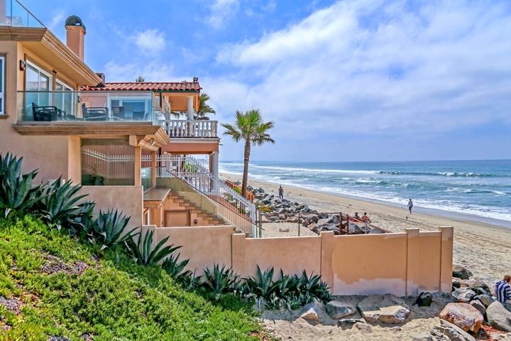 Beachfront homes in Oceanside, CA with wide sandy beaches, highlighting the more affordable coastal living options in North County San Diego.
