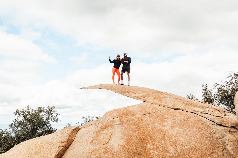 Karen Pietsch and Ty Hines standing on Potato Chip Rock in Poway, California